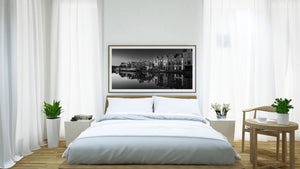 A panoramic monochrome photograph captures canal-side architecture in Haarlem