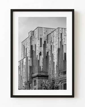 Geometric brickwork and tall decorative panels rise across a Haarlem façade in black and white