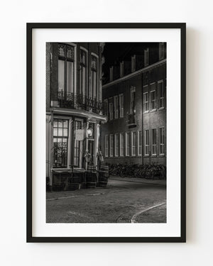 A Haarlem wine bar and rows of bicycles glow softly at night in black and white