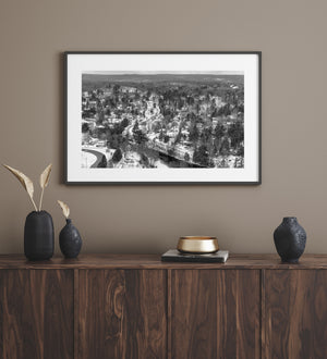 A winter village landscape stretches toward wooded Ontario hills