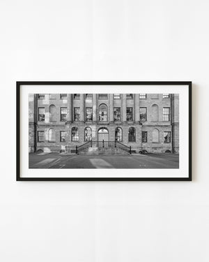 Stone columns and arched windows line Province House in Halifax in black and white