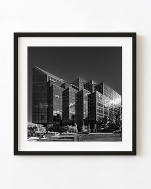 Angular glass façades of the PwC office building in Halifax reflect clouds in black and white