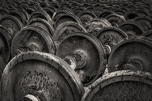 close view of weathered train wheels with rust texture in black and white