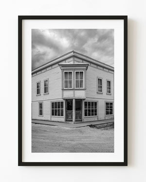 Harrington’s Store in Dawson City stands beneath cloudy skies in black and white