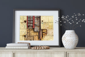 Urban decay photograph of a damaged window and textured yellow wall in Havana.