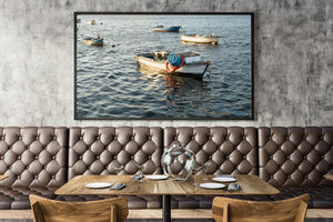 Anchored fishing boats on blue-grey harbour water in a colour Havana waterfront photograph.