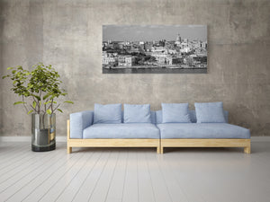 Monochrome Havana skyline seen across the water beneath scattered clouds.