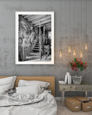 Surreal mural across a textured Havana wall beside an aging staircase and potted plants.