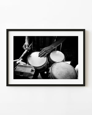Close-up of a Havana percussionist’s hands playing drums, photographed in black and white.