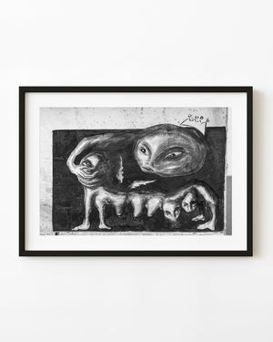Surreal creature mural with multiple human-like faces on a Havana wall in black and white.