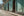 Colour street photograph of turquoise walls, ornate iron grilles and painted Fidel lettering in Havana.
