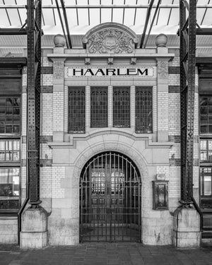 Historic Dutch railway entrance with arched gate