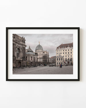 Historic German buildings with ornate facades and a domed roof around a cobblestone old town square.