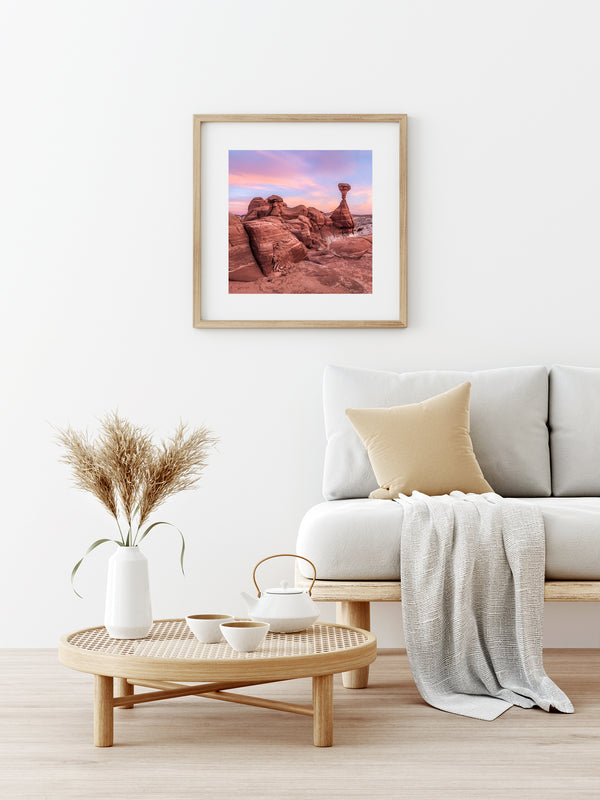 Rock formations under pink sunset sky