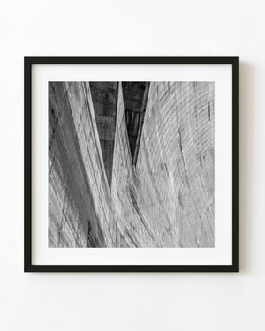 Abstract black and white view of Hoover Dam’s curved concrete walls and sweeping geometric lines.