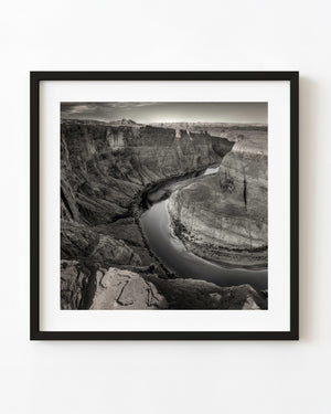 Black and white Horseshoe Bend landscape with the Colorado River curving around towering canyon walls.