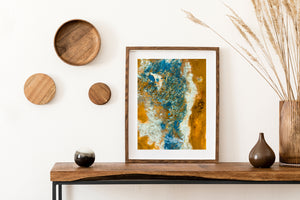 Aerial photograph of blue and gold geothermal patterns across textured Icelandic ground.