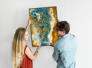 Icelandic mineral terrain seen from above, with scattered blue pools across gold and cream textures.