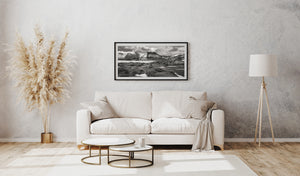 Black and white photograph of Iceland’s rocky landscape, snow-dusted peaks and shallow foreground water.