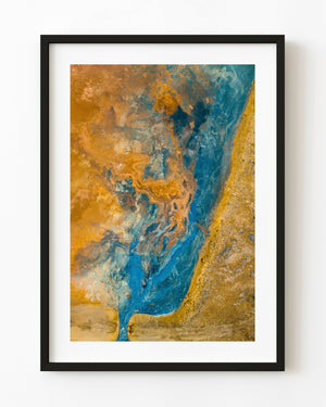 Turquoise mineral channel weaving through golden Icelandic ground, photographed from directly above.