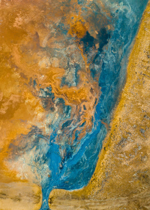 A blue-green channel curves across ochre geothermal terrain in an abstract Icelandic aerial view.