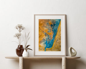 Abstract Icelandic landscape with a winding turquoise band and textured yellow-orange terrain.
