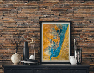 A turquoise geothermal channel with pale swirling textures amid golden ground in Iceland.