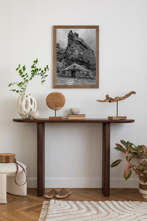 Historic Icelandic stone and grass house under steep rock cliff