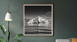 Textured glacier ice formation rising above still water