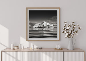 Broken glacier iceberg with reflection in Iceland lagoon