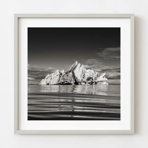 Black and white iceberg floating in Iceland glacier lagoon