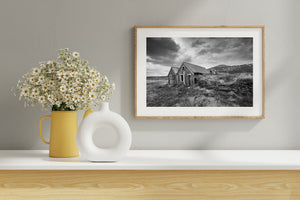 historic Iceland farmhouse ruins in mountain landscape black and white