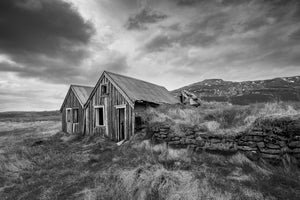 weathered wooden Iceland farmhouse with grass covered roof monochrome