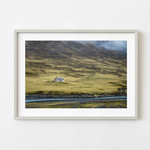 Isolated farmhouse in rural Iceland valley beside a river