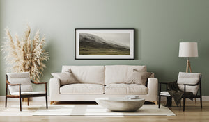 Quiet Iceland meadow with farmhouse cluster and low cloud mountain