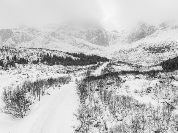 Snow-covered road in Norwegian winter landscape