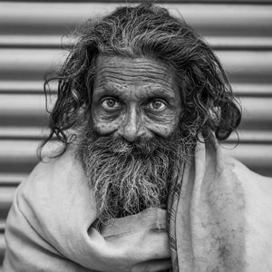 Close portrait of an elderly Indian man with a long beard