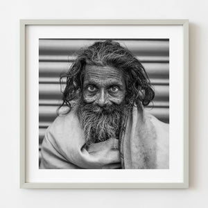 Black and white street portrait of an elderly man in India