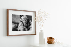 Indian elderly woman seated indoors black and white portrait