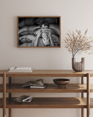 worker surrounded by sacks in black and white portrait