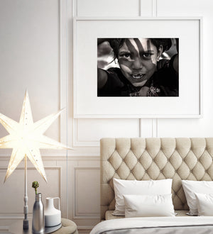 high contrast sepia portrait child shielding eyes from sun