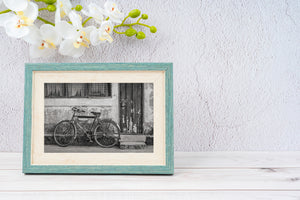 worn bicycle resting on cracked concrete step vintage style