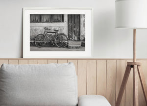 distressed building facade with leaning bicycle monochrome