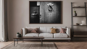 Black and white mechanical photograph with scratched metal surfaces and a diagonal lever shadow.