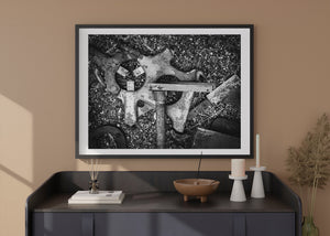 Rough ground contrasts with smooth edges and weathered surfaces of abandoned industrial tools.