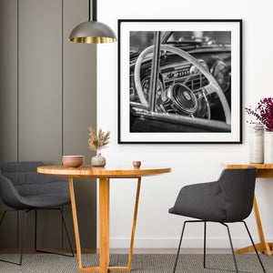 Black and white image of a vintage Cadillac sedan interior