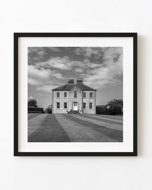 Black and white photograph of a rural manor house in Ireland