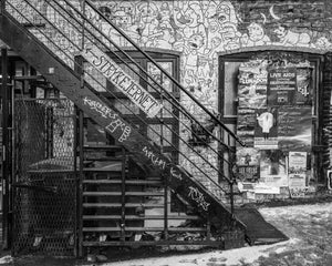 Textured urban scene with iron stairs and colorful graffiti in Norway