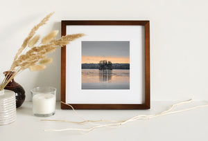 Snowy shore against spring sunset