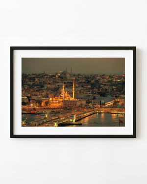 Istanbul at dusk with illuminated mosques, Galata Bridge and golden reflections across the waterfront.
